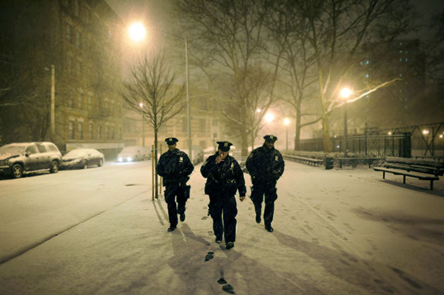 Officers walk through a snowstorm in the Mott Haven neighborhood of the Bronx.