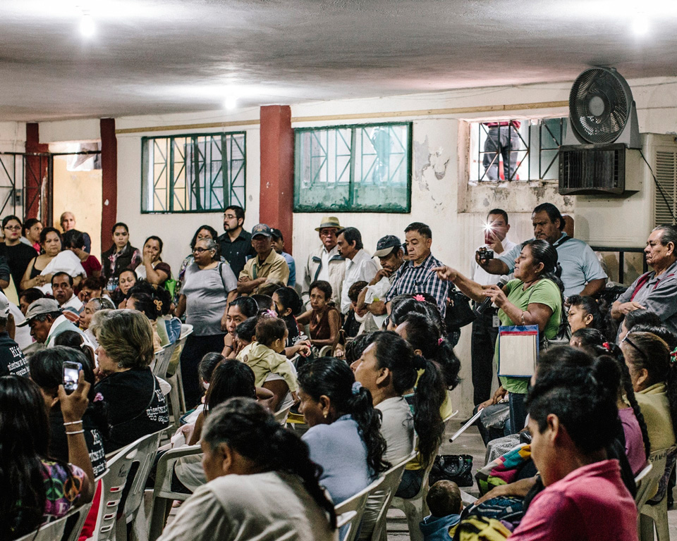 Towns people gather with law enforcement officials during a town hall at the San Gerardo church to air their concern that the government has not done enough to find their missing.