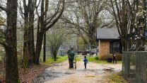 Three Black residents in a driveway in Lowndes County, Alabama