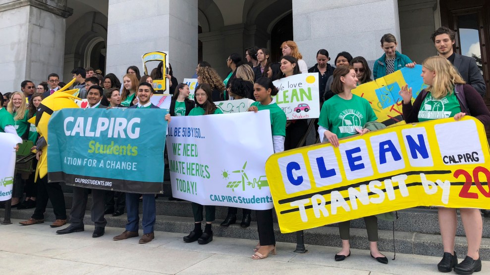 Around 30 students standing on steps in front of the California Capitol with signs like "Clean Transit by 2030" and "CALPIRG Students: Action for a Change"