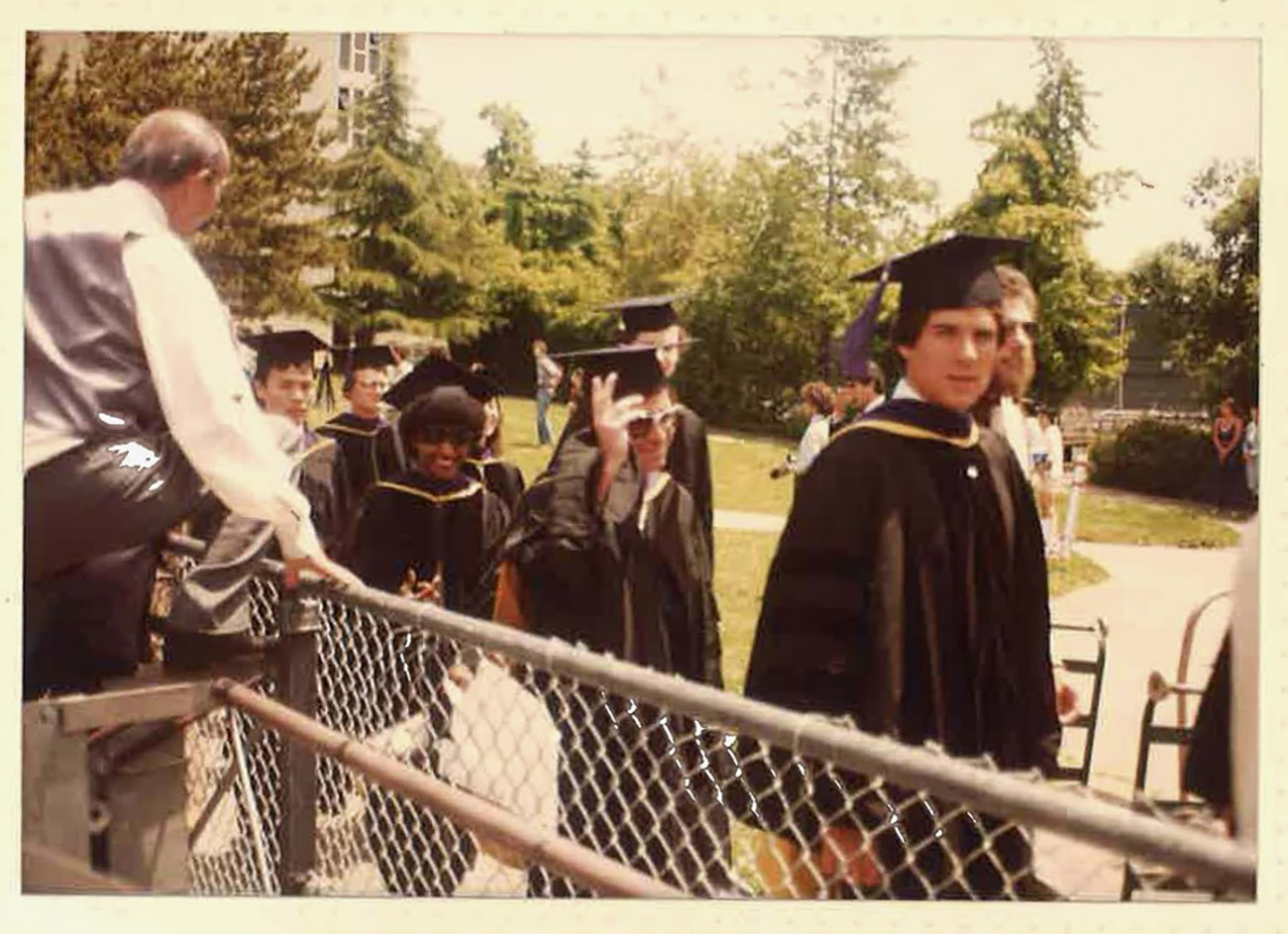 Line of graduates in caps and gowns.