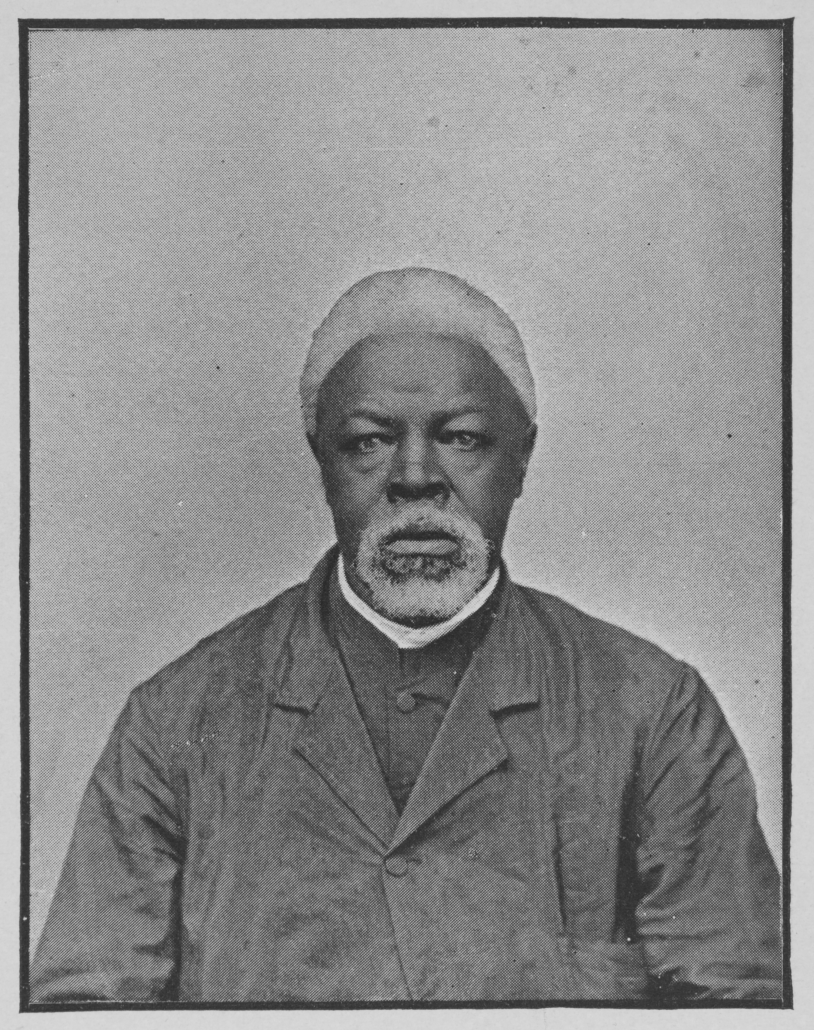 Black-and-white portrait of a Black man with white hair.