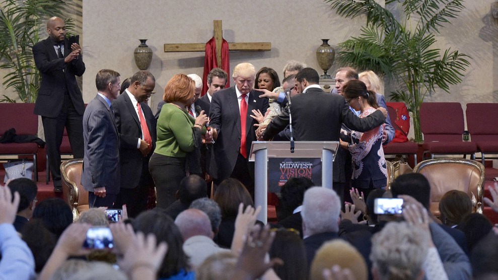 Pastors and attendees lay hands on and pray over Donald Trump