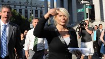 Kristin Davis outside court in New York City, surrounded by attorneys and media reporters.