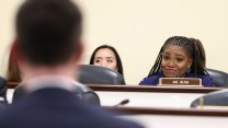 Representative Cori Bush sits in a congressional meeting.