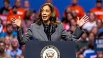 Kamala Harris giving speech behind a podium at a campaign rally.