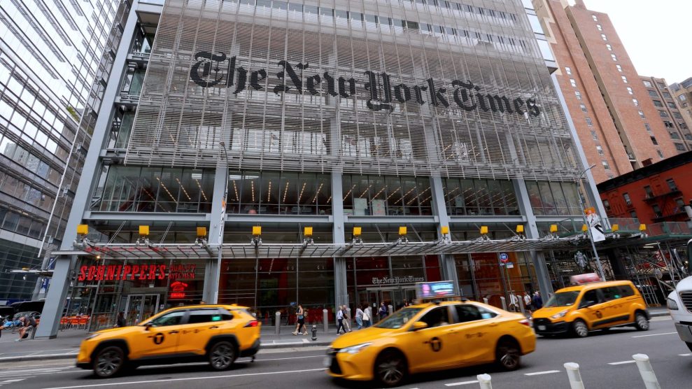 A photo of the New York Times building with taxis in the foreground