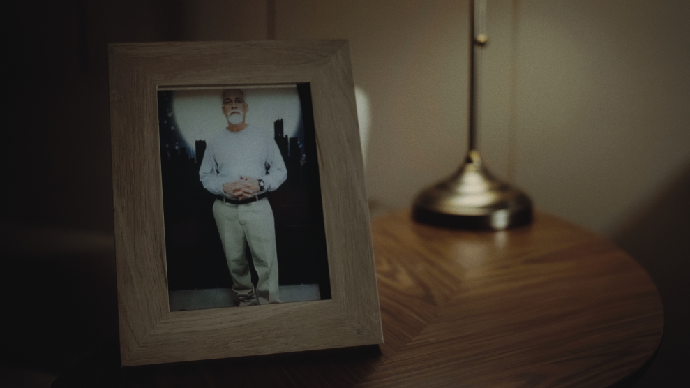 A still image from a documentary depicting a picture frame of an older gentleman (Pedro Moreno) standing in front of a backdrop of a night city.