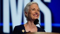 Close-up photo of Cecile Richards standing behind a microphone, smiling.