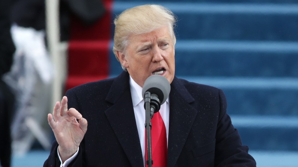 Donald Trump stands at a microphone.