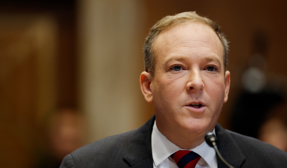 Lee Zeldin's face, framed close up, to the right