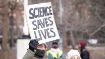 A sign, "Science Saves Lives"