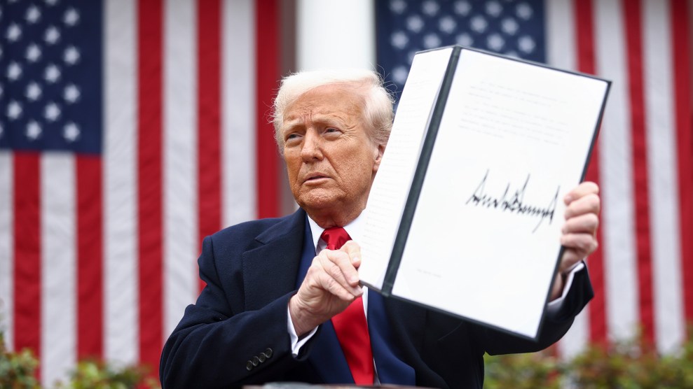 US President Donald Trump holds up a signed executive order implementing new reciprocal tariffs against US trading partners in the Rose Garden of the White House in Washington, DC.