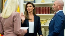 Attorney General Pam Bondi, wearing a light-colored jacket, swears in Alina Habba, center, holding her right hand up during her swearing-in, with her husband, Gregg Reuben, in a suit coat, holding the Bible to the right.
