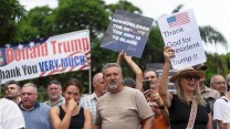 White demonstrating South Africans holding signs, including one that reads, "Thank God for President Trump!!""
