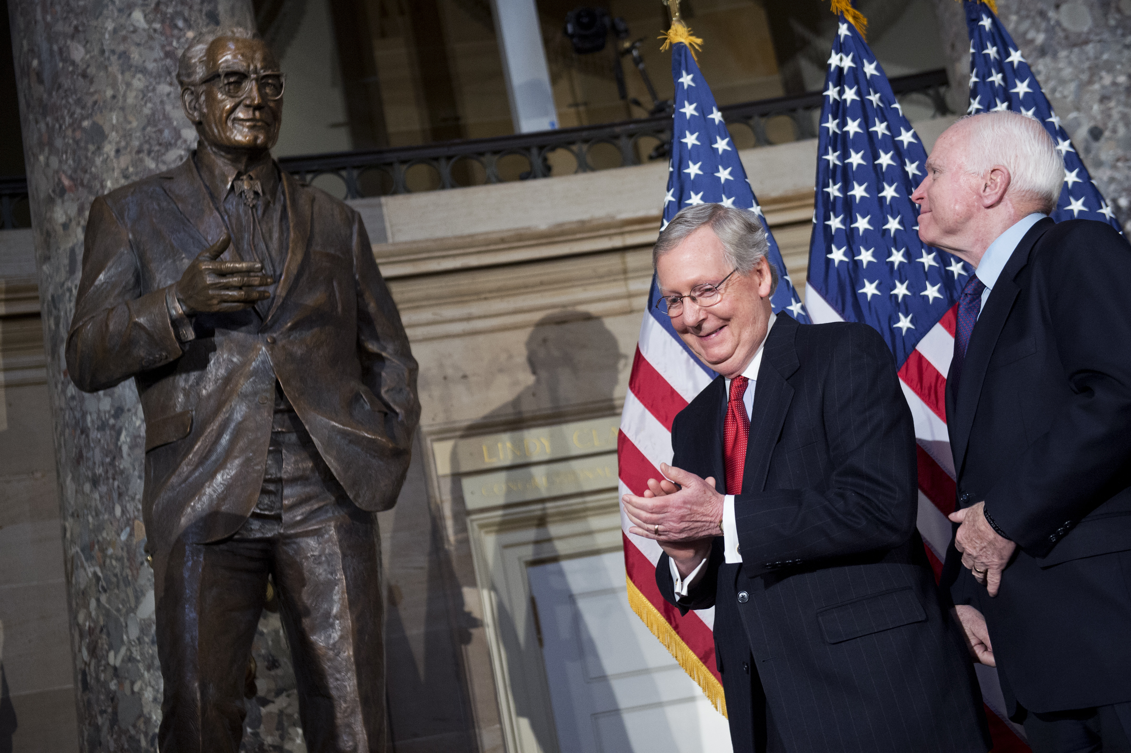 Senators Mitch McConnell and John McCain standing next to a statue of Sentator Barry Goldwater.