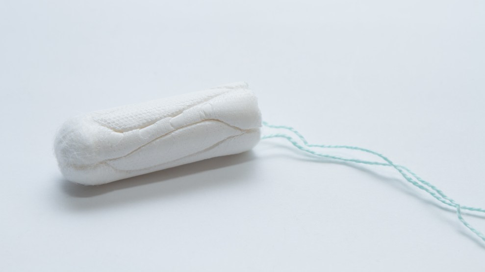 Close up of a tampon on a pale blue background.