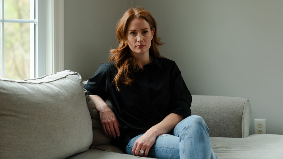 Portrait of red-haired woman sitting on a couch.