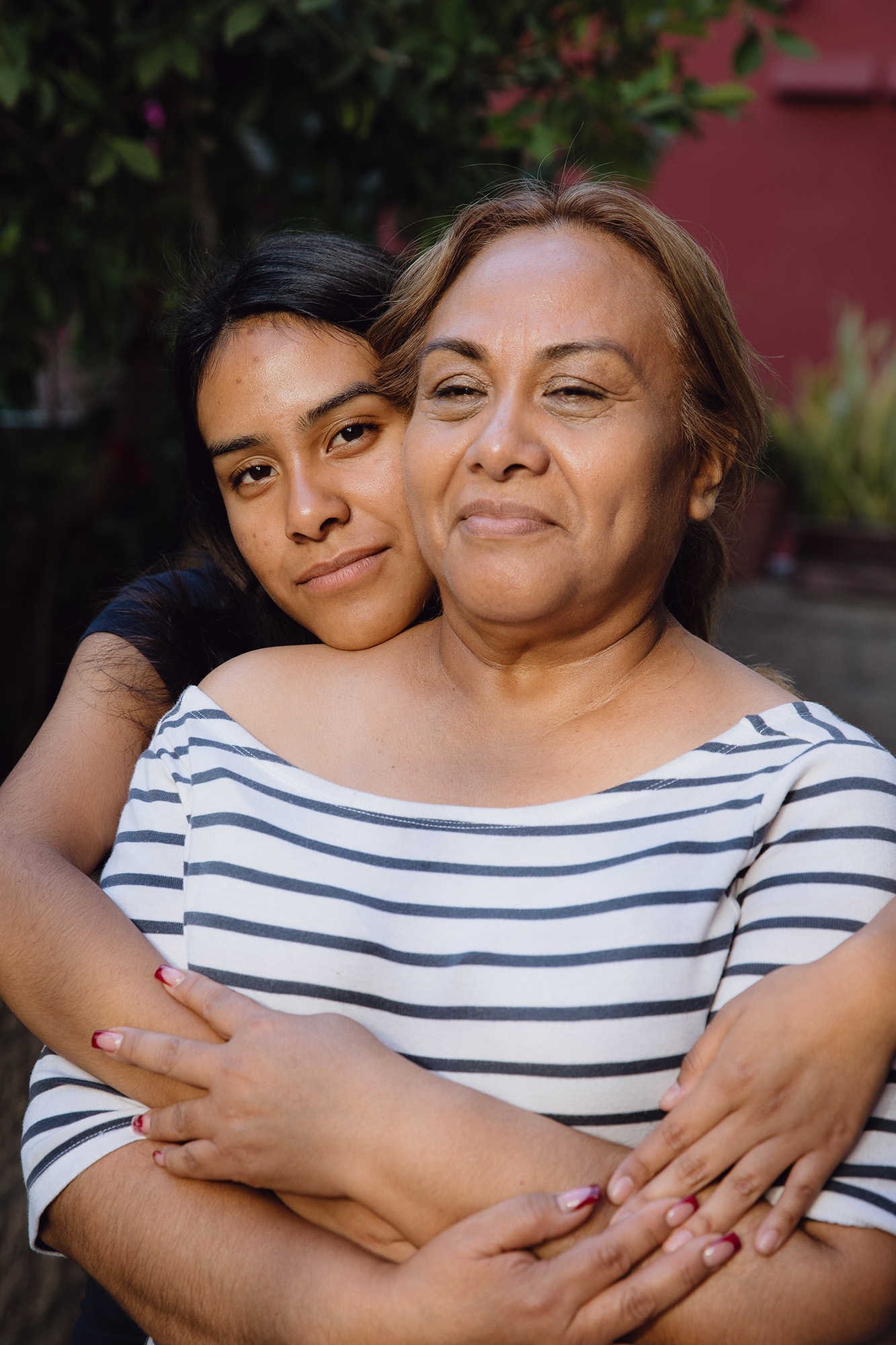 Teenage Daughter hugging her mother.