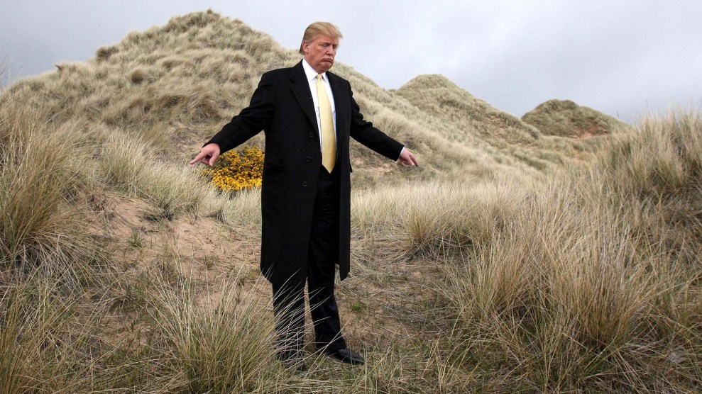 Donald Trump standing on sand dunes.