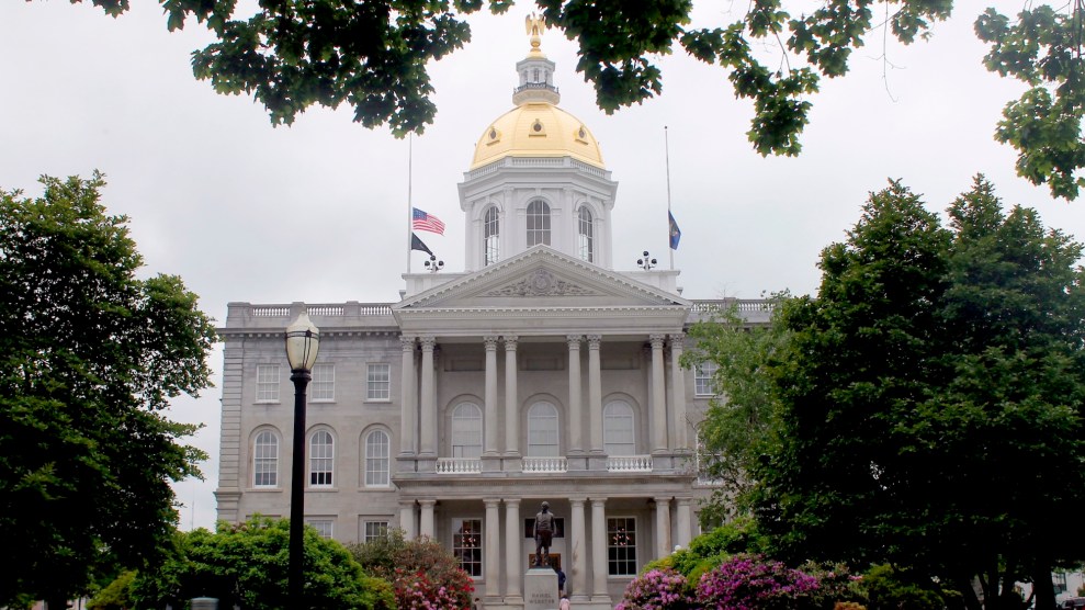 A old gray stone building with a golden dome on top.