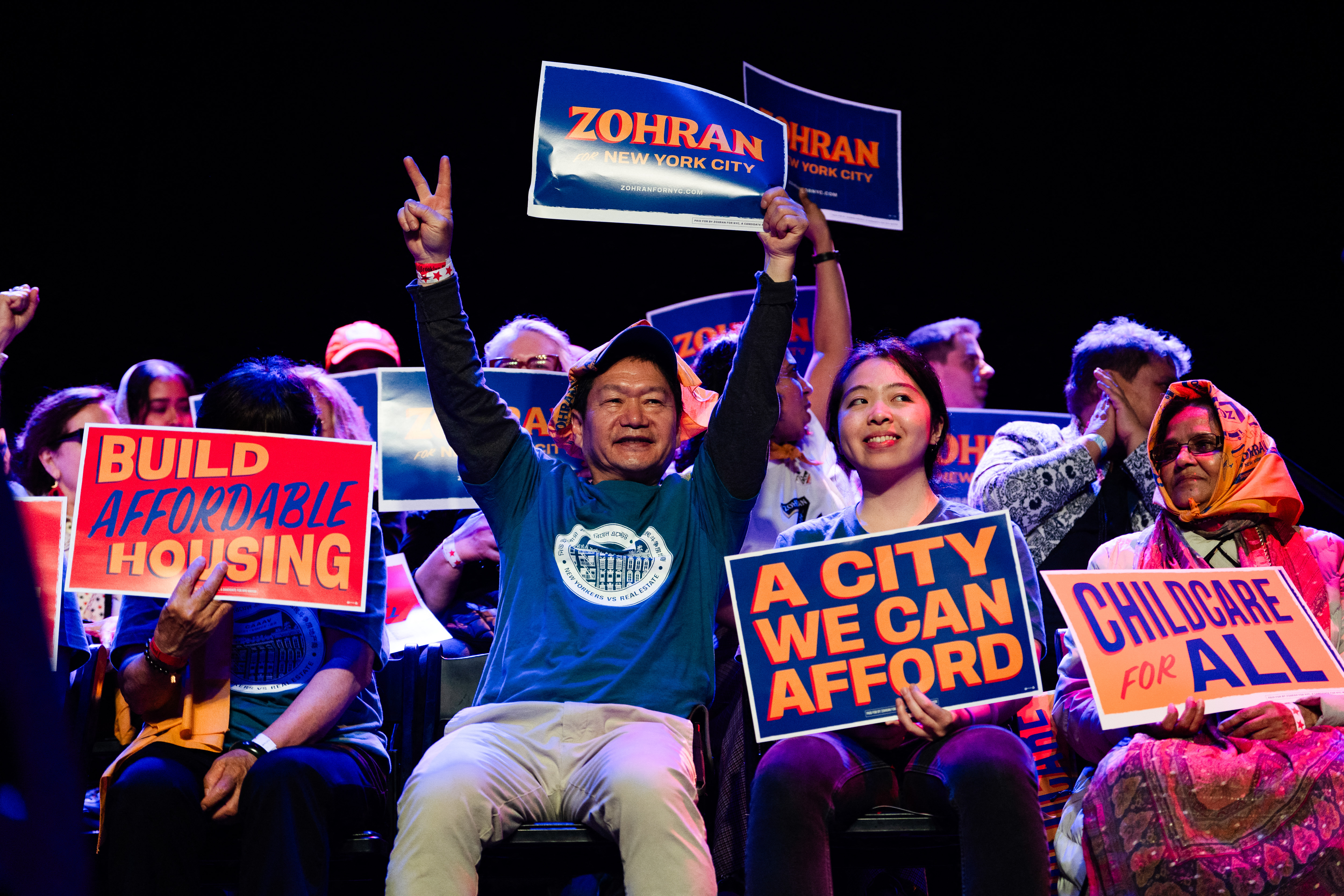 Supporters holding campaign signs and cheering