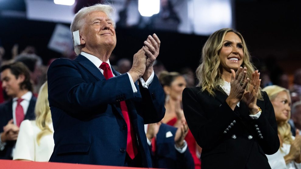 President Donald Trump and daughter-in-law Lara Trump standing, smiling, and clapping at the Republican National Convention.