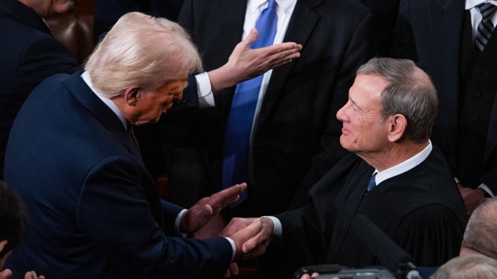 President Donald Trump greets Chief Justice John Roberts before Trump delivered his address to a joint session of Congress in the House Chamber of the US Capitol.