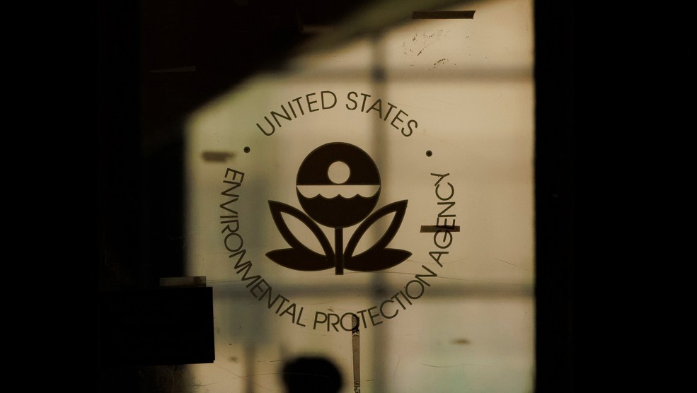 A close-up image of the EPA's emblem on a shadowed glass door.