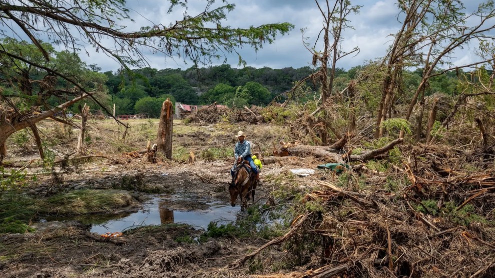 A person on horseback walking through a pond.