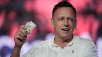 Peter Thiel holding a pair of $100 bills.