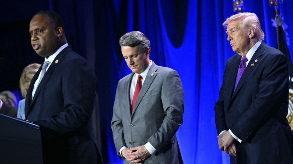Jackson stands in front of Trump at a podium speaking.