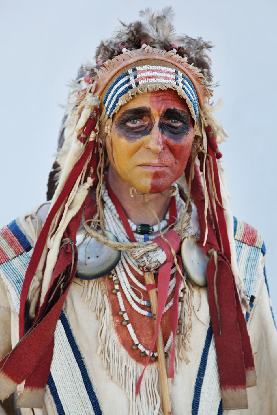 Portrait of man dressed as Native American.