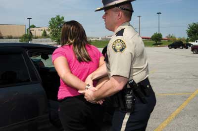 A police officer handcuffing a woman