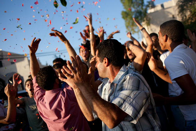 Men from the town of Wadi Fukin participate in a wedding celebration.