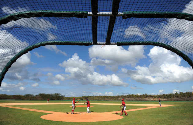 A Nationals scout, center, runs drills with local players during a tryout at the Complex de las Américas in February 2011 in Boca Chica. 