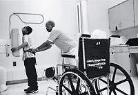 A technician at Cook County Hospital gets Esosa lined up for a lung X-ray.